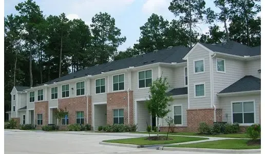 front view of a brick house next to a yard