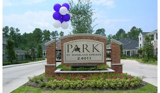 a view of sign board with flower around