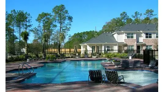 a front view of a house with lake view and a garden