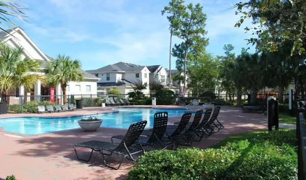 a view of a patio with dining table and chairs with a fire pit