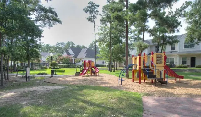 a view of park with swings and slides