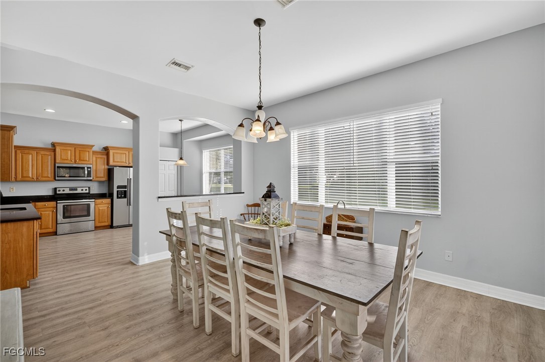 12899 Ivory Stone Loop Fort Myers, FL 33913 - Photo 12 of 40 a view of a dining room with furniture window and wooden floor