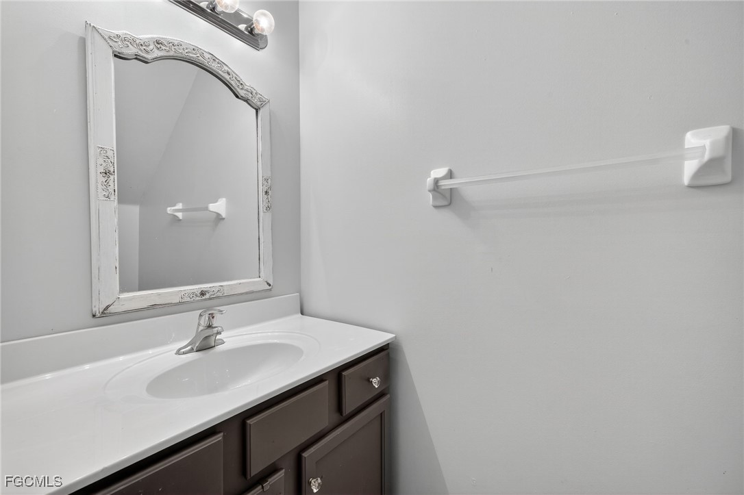 12899 Ivory Stone Loop Fort Myers, FL 33913 - Photo 13 of 40 a bathroom with a sink a vanity and a mirror