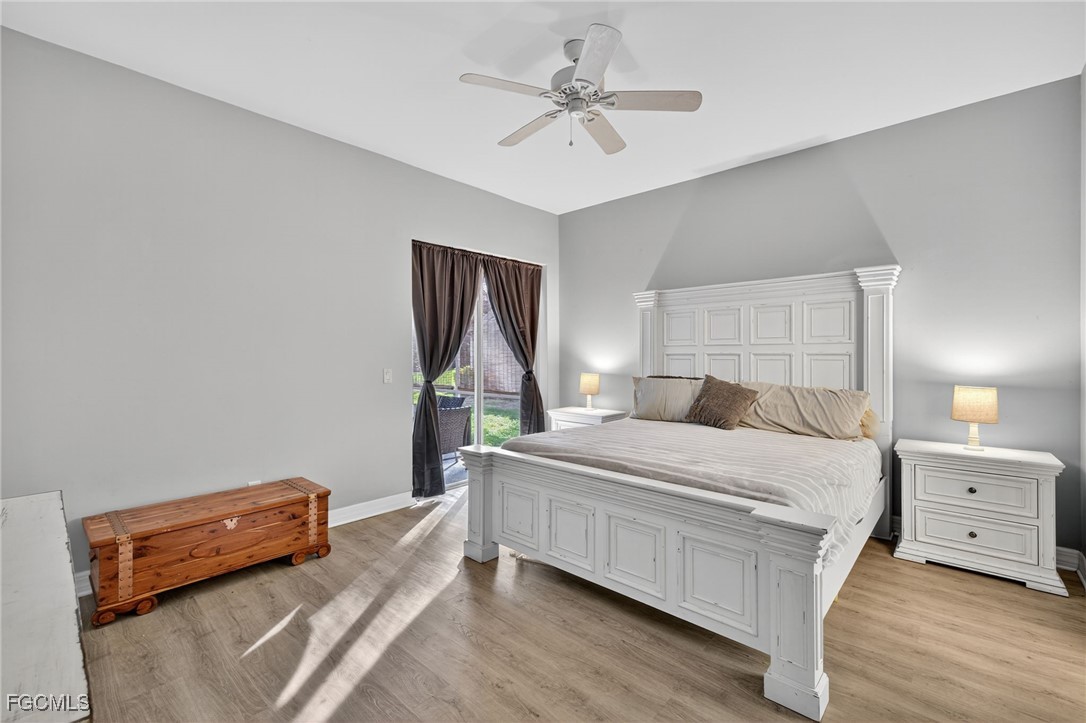 12899 Ivory Stone Loop Fort Myers, FL 33913 - Photo 14 of 40 a bedroom with a bed and a chandelier