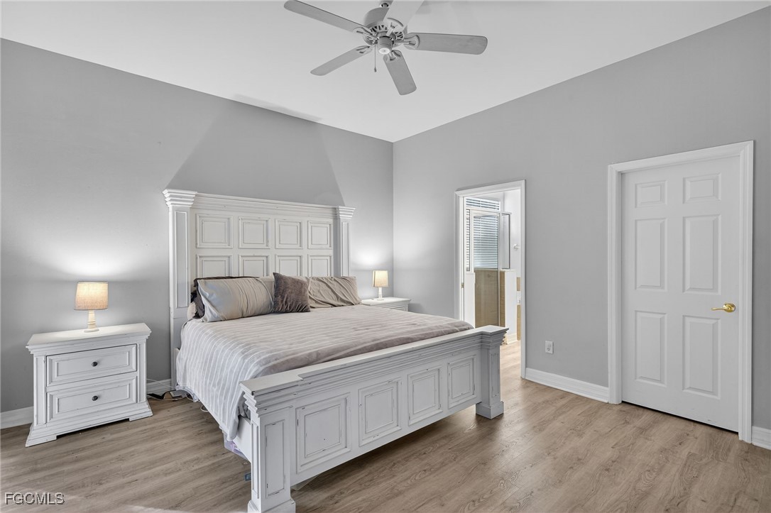 12899 Ivory Stone Loop Fort Myers, FL 33913 - Photo 15 of 40 a bedroom with a bed and a chandelier