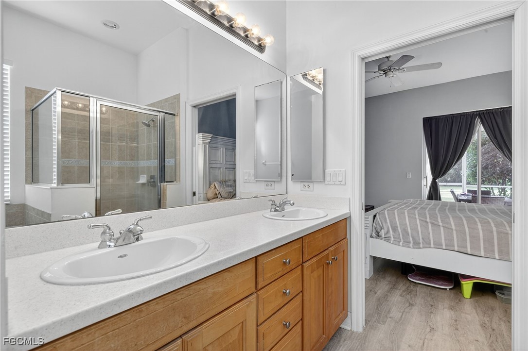 12899 Ivory Stone Loop Fort Myers, FL 33913 - Photo 18 of 40 a bathroom with a sink double vanity and a mirror