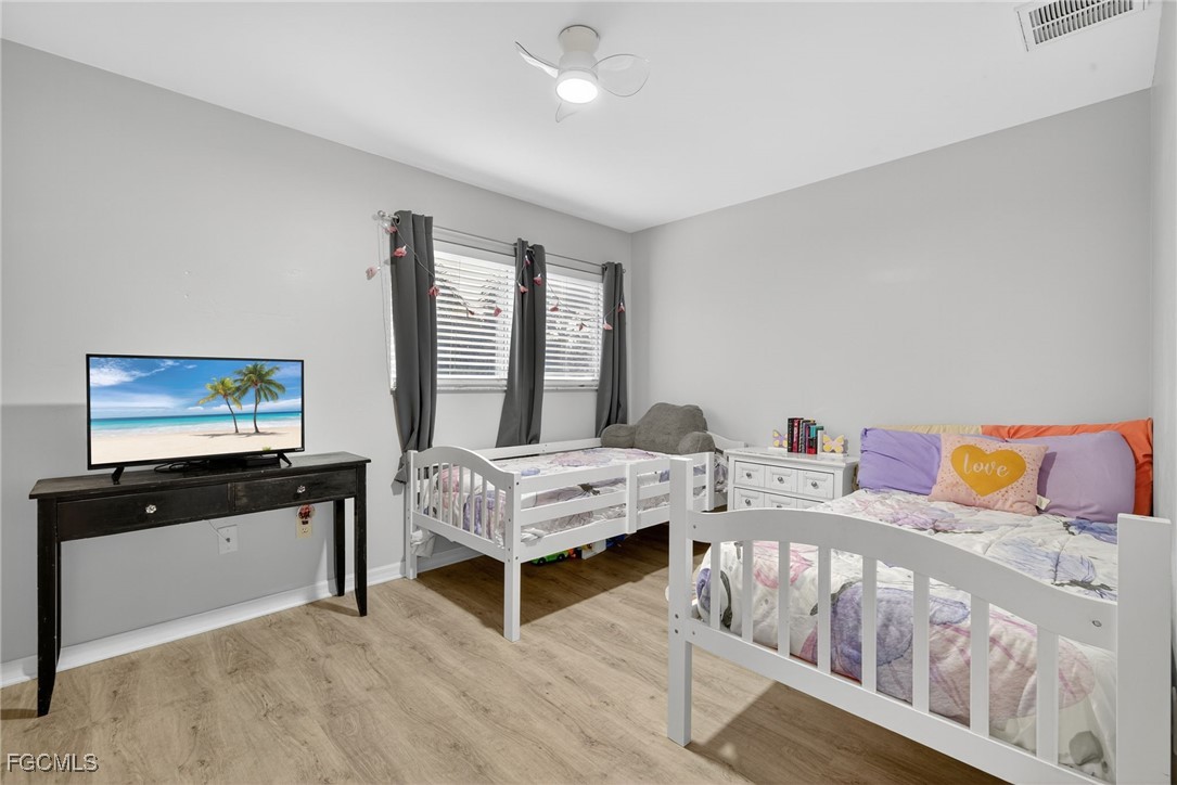12899 Ivory Stone Loop Fort Myers, FL 33913 - Photo 22 of 40 a bedroom with furniture and a flat screen tv