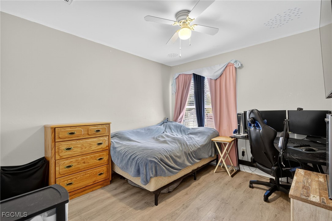 12899 Ivory Stone Loop Fort Myers, FL 33913 - Photo 23 of 40 a bedroom with a bed and a chandelier
