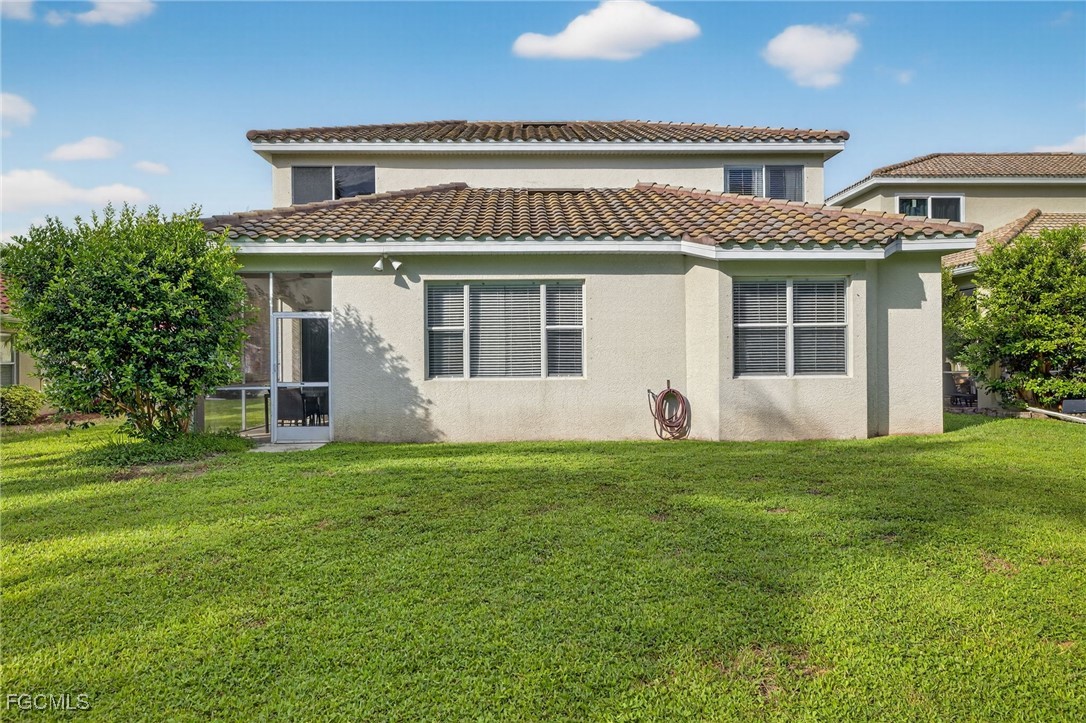 12899 Ivory Stone Loop Fort Myers, FL 33913 - Photo 26 of 40 a front view of a house with a garden