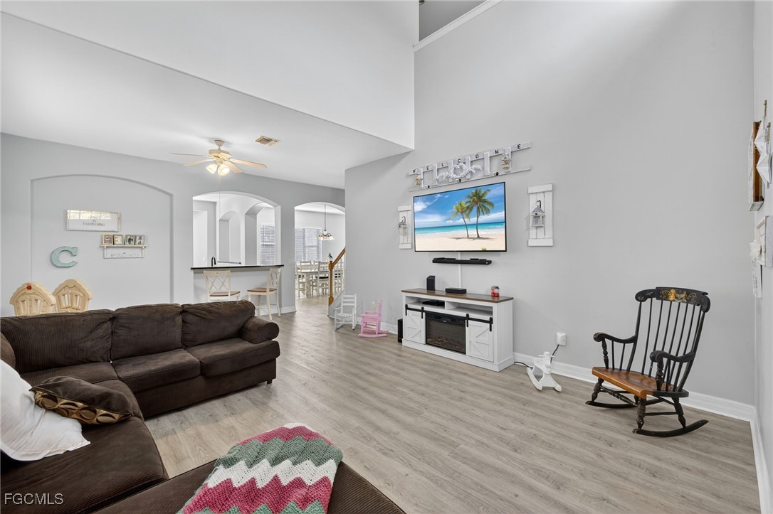 12899 Ivory Stone Loop Fort Myers, FL 33913 - Photo 3 of 40 a living room with furniture and a dining table with wooden floor