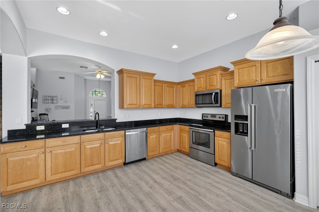 12899 Ivory Stone Loop Fort Myers, FL 33913 - Photo 9 of 40 a kitchen with granite countertop a sink stainless steel appliances and cabinets