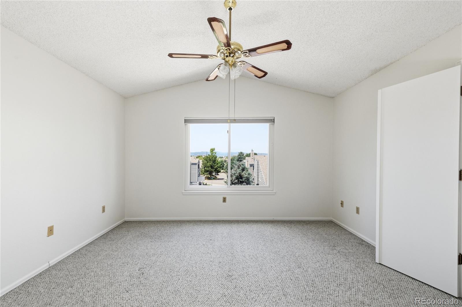 155 Blue Spruce Court Highlands Ranch, CO 80126 - Photo 16 of 29 an empty room with a window and a ceiling fan