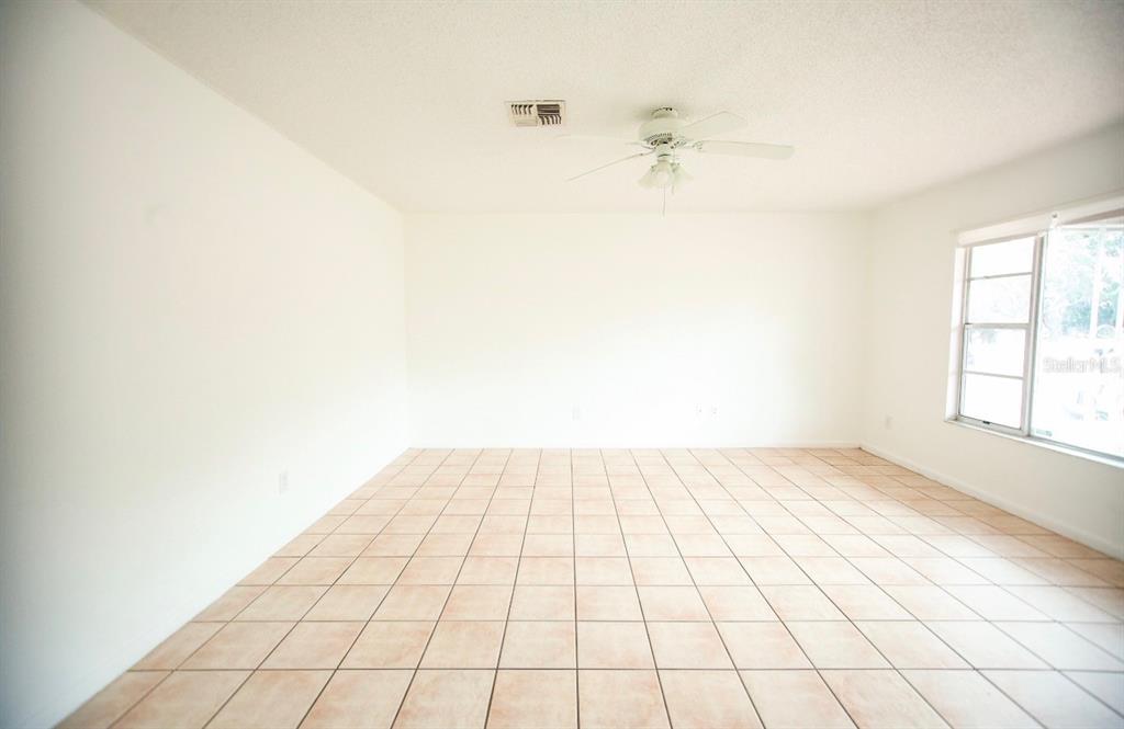 606 Water Road Ocala, FL 34472 - Photo 27 of 34 an empty room with a white wall and a window