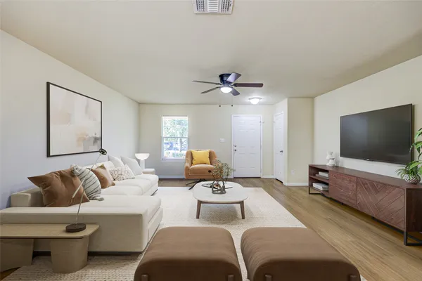 a living room with furniture and a flat screen tv