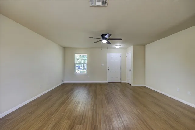 a kitchen with stainless steel appliances granite countertop a stove top oven a sink and dishwasher a refrigerator with wooden floor