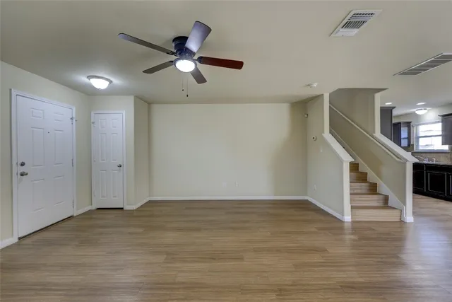 a kitchen with granite countertop wooden cabinets stainless steel appliances a sink and a window
