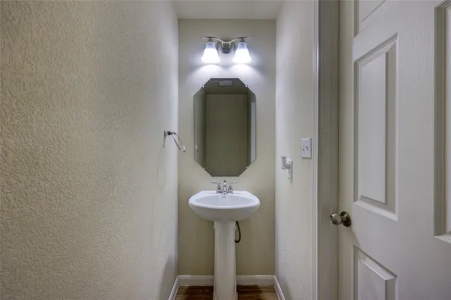 a bathroom with a double vanity sink and a mirror