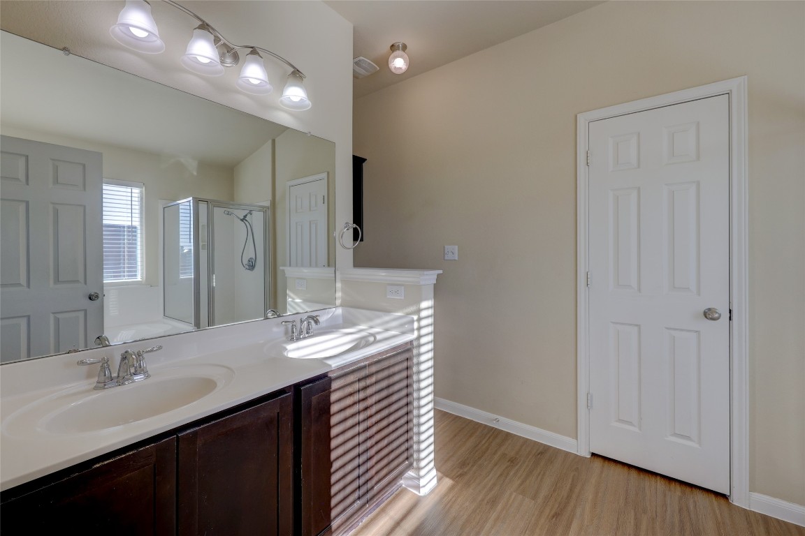 267 Voyager Cove Kyle, TX 78640 - Photo 21 of 40 a bathroom with a double vanity sink and a mirror