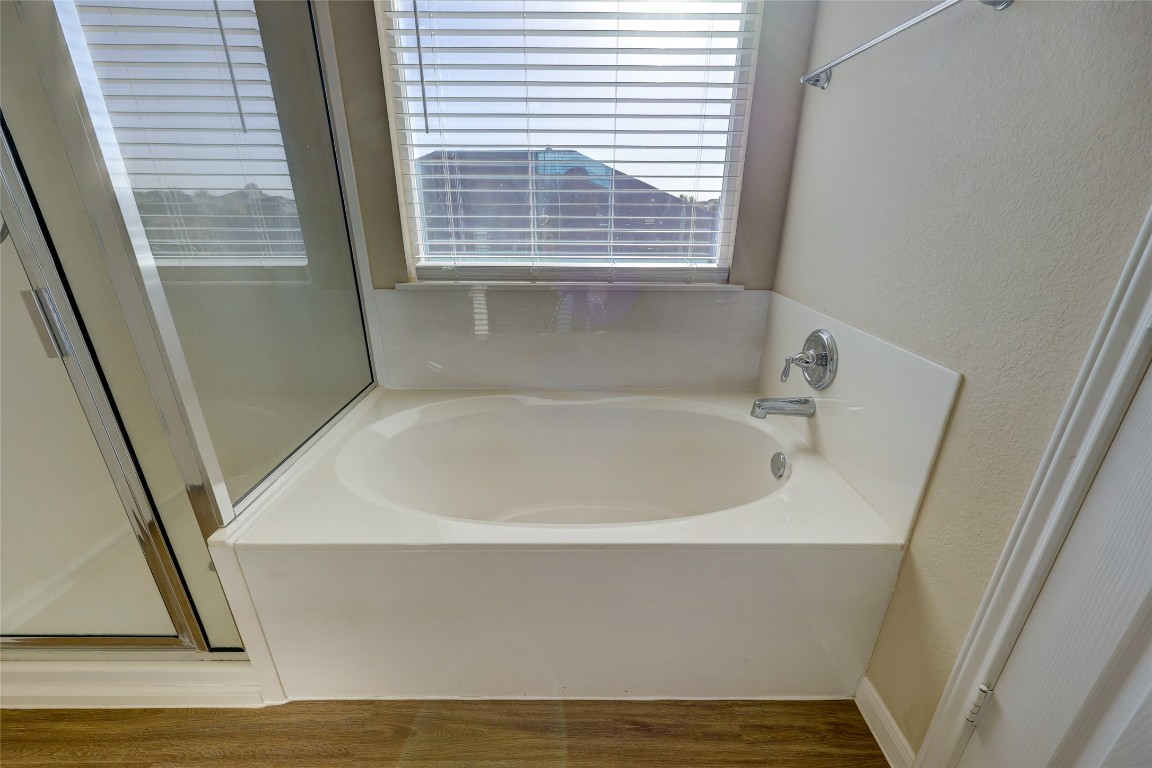 267 Voyager Cove Kyle, TX 78640 - Photo 23 of 40 a white bath tub sitting next to a window