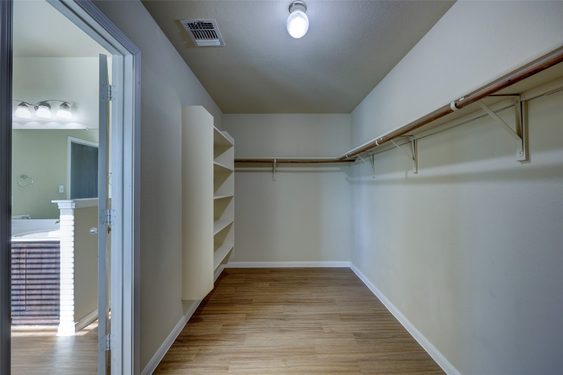 267 Voyager Cove Kyle, TX 78640 - Photo 25 of 40 a view of a hallway with wooden floor and staircase