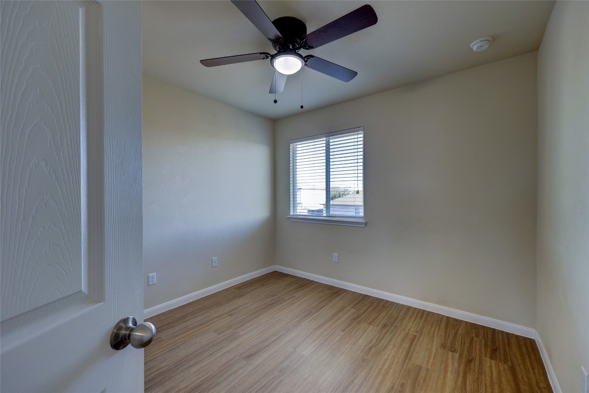 267 Voyager Cove Kyle, TX 78640 - Photo 28 of 40 an empty room with a window and a ceiling fan