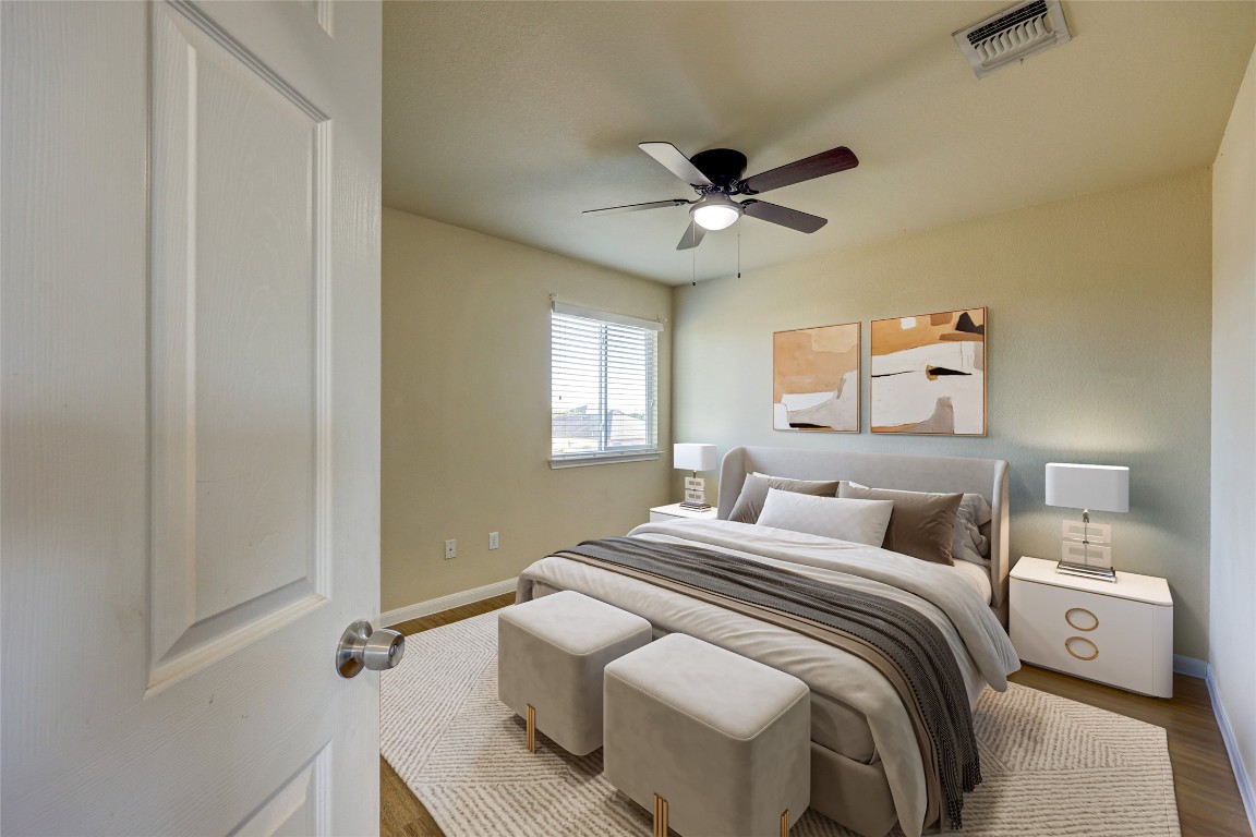 267 Voyager Cove Kyle, TX 78640 - Photo 3 of 40 a bedroom with a bed and a ceiling fan