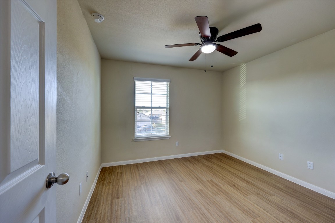 267 Voyager Cove Kyle, TX 78640 - Photo 31 of 40 wooden floor in an empty room with a window