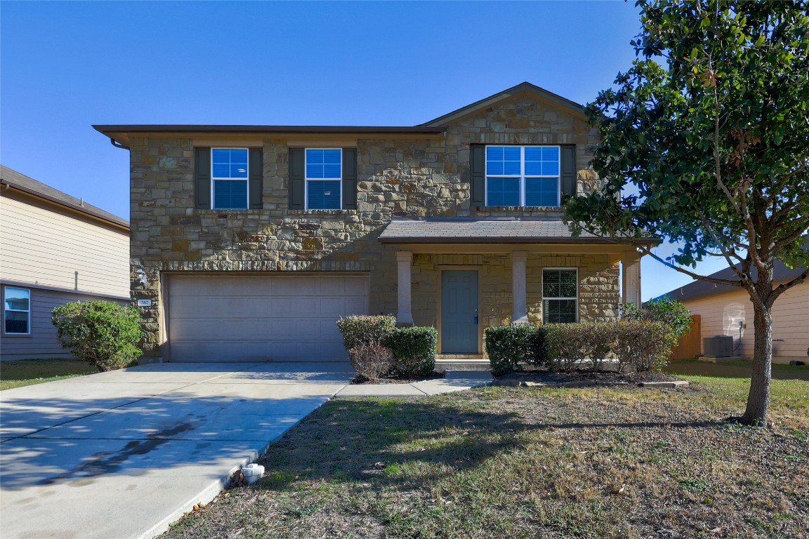 267 Voyager Cove Kyle, TX 78640 - Photo 9 of 40 a front view of a house with garden