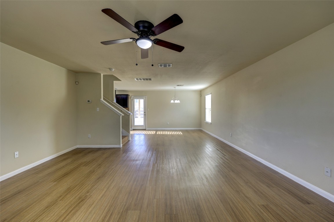 267 Voyager Cove Kyle, TX 78640 - Photo 40 of 40 an empty room with wooden floor and windows