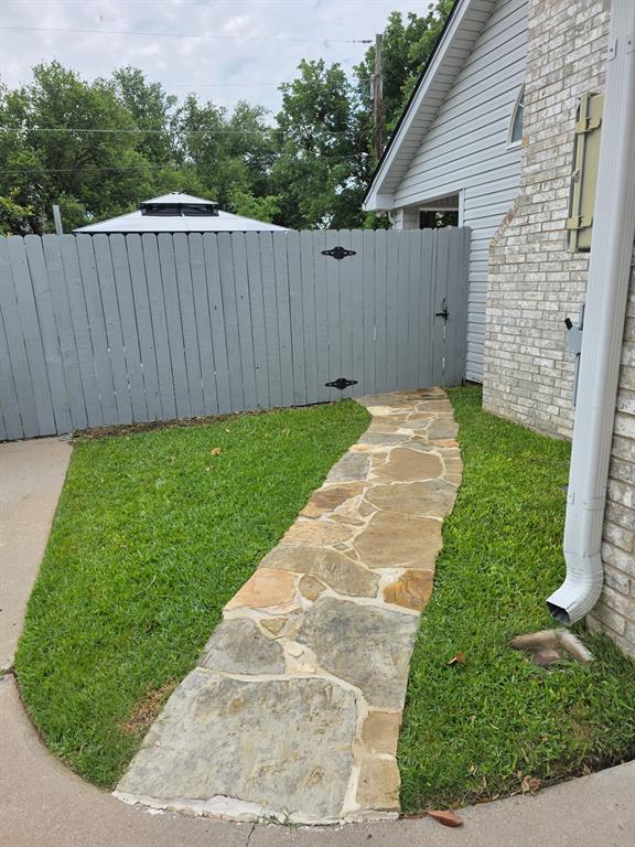 520 Red River Road Belton, TX 76513 - Photo 28 of 36 Stone pathway leading to a privacy fence with decorative iron hardware