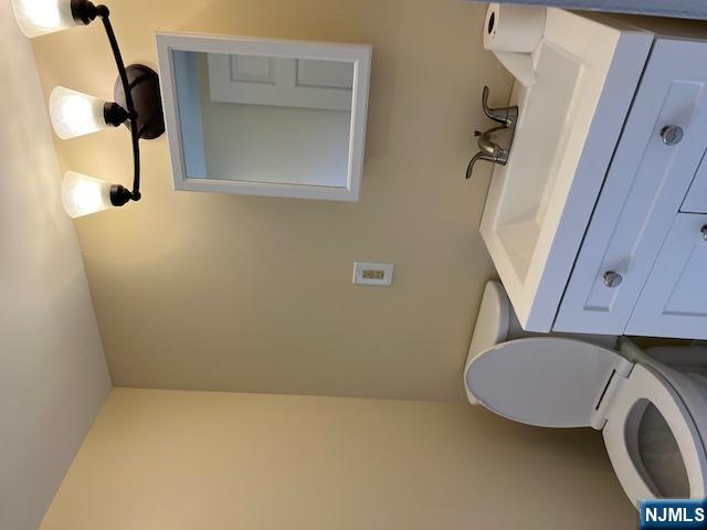 404 Stonetown Road Ringwood, NJ 07456 - Photo 8 of 13 a bathroom with a toilet sink and mirror