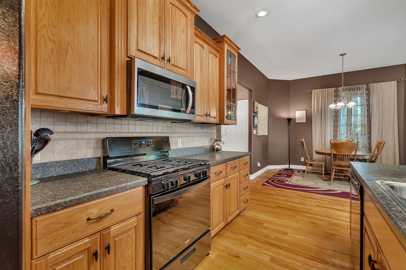 300 Village Lane Seneca, IL 61360 - Photo 12 of 42 a kitchen with stainless steel appliances granite countertop a stove a sink and a microwave