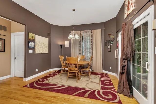 a living room with furniture a dining table and a large window