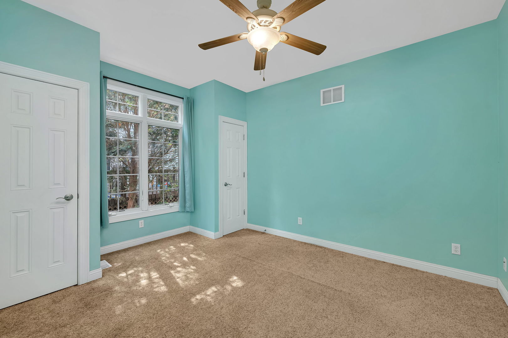 300 Village Lane Seneca, IL 61360 - Photo 20 of 42 a view of a room with a ceiling fan and a window