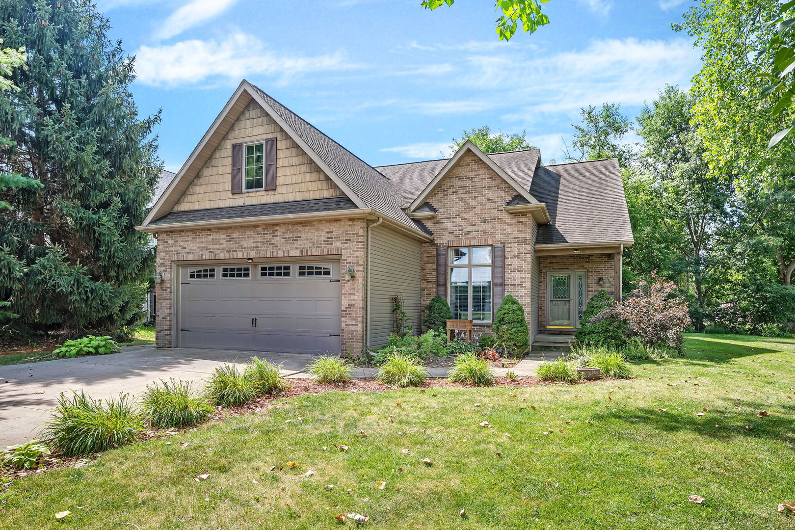 300 Village Lane Seneca, IL 61360 - Photo 2 of 42 a front view of a house with a yard and garage