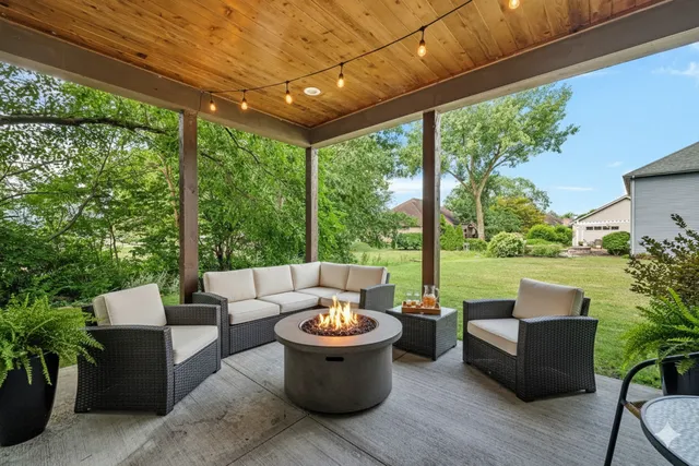 a view of a patio with couches and potted plants