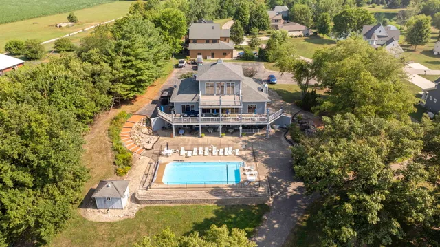 an aerial view of a house with a yard