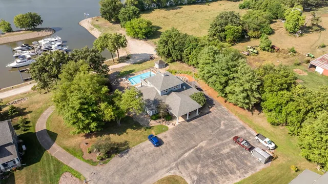 an aerial view of a house with a yard and trees