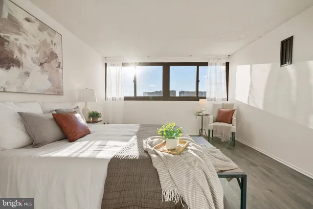 a bedroom with a bed and a couch