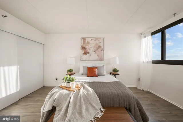 a bedroom with a bed and a window