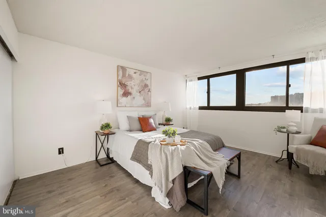 a bed room with a bed and a chair