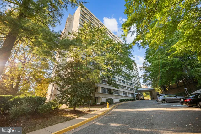 a city street lined with buildings and trees