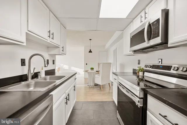 a kitchen with stainless steel appliances granite countertop a sink and stove