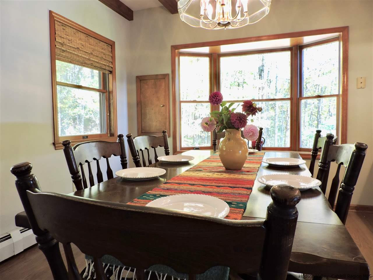 2579 Vega Mountain Road Roxbury, NY 12421 - Photo 8 of 34 a view of a dining room with furniture a chandelier and wooden floor