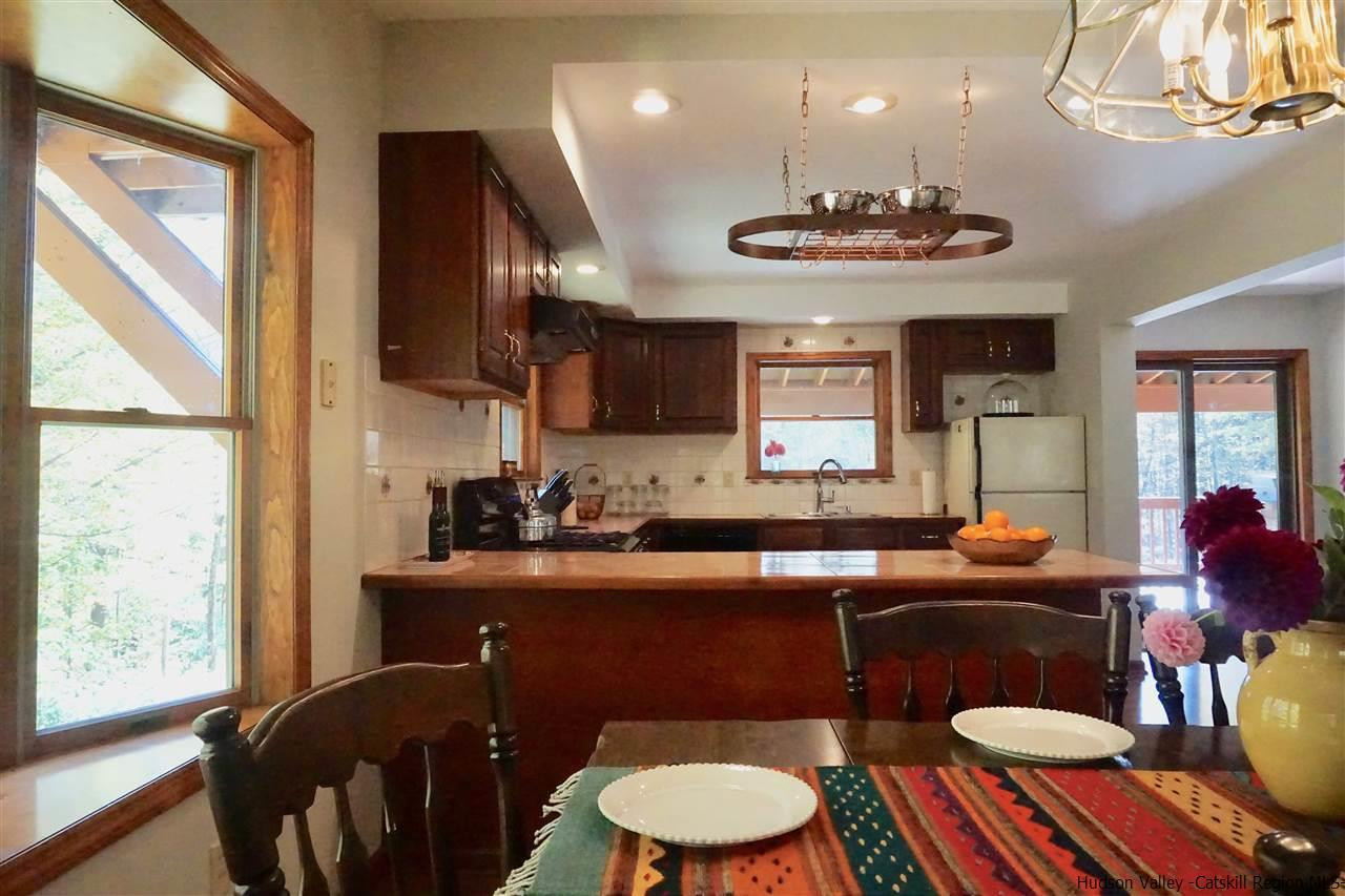 2579 Vega Mountain Road Roxbury, NY 12421 - Photo 10 of 34 a kitchen with a table chairs stove and microwave