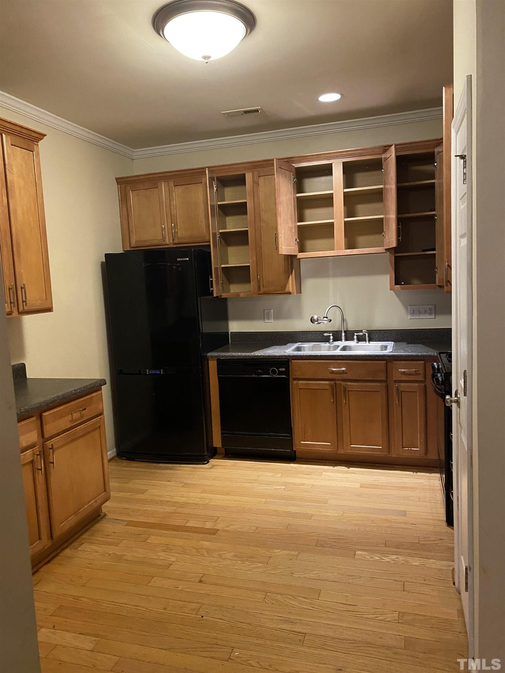 11711 Coppergate Drive, Unit 107 Raleigh, NC 27614 - Photo 4 of 10 a kitchen with stainless steel appliances granite countertop a stove a refrigerator and a sink