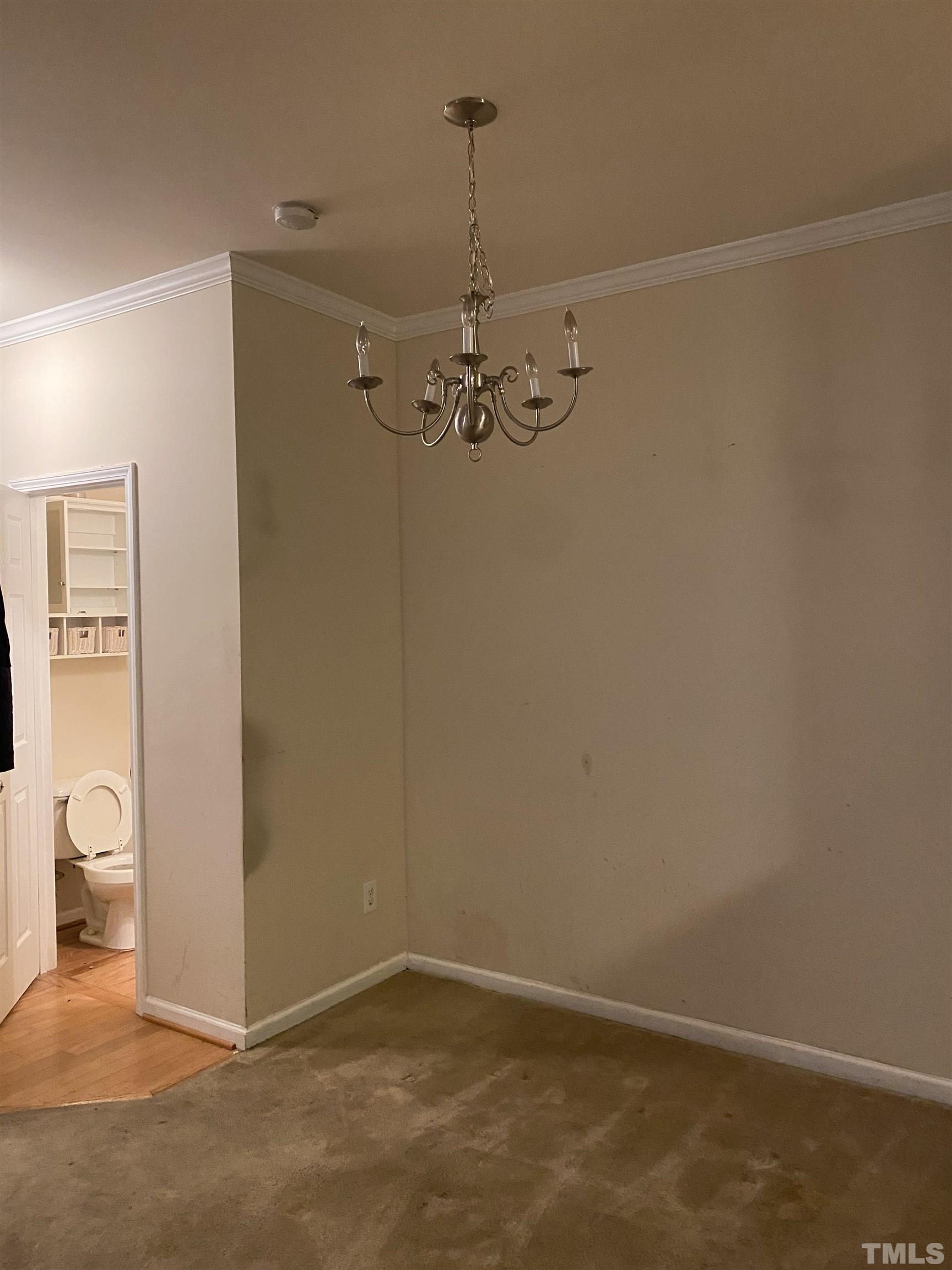 11711 Coppergate Drive, Unit 107 Raleigh, NC 27614 - Photo 7 of 10 a view of a room with a hanging light and kitchen