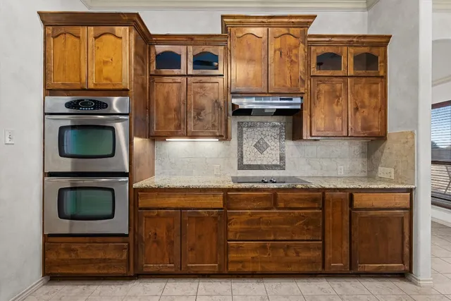 a kitchen with stainless steel appliances granite countertop a stove and a microwave