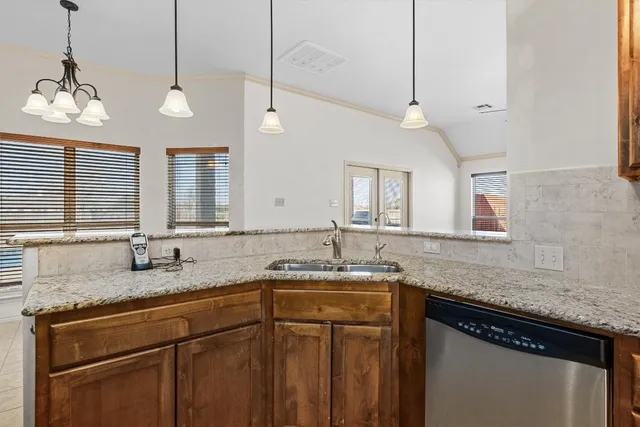 a kitchen with a sink and a granite counter top