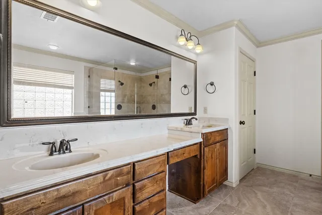 a bathroom with a sink double vanity and a mirror